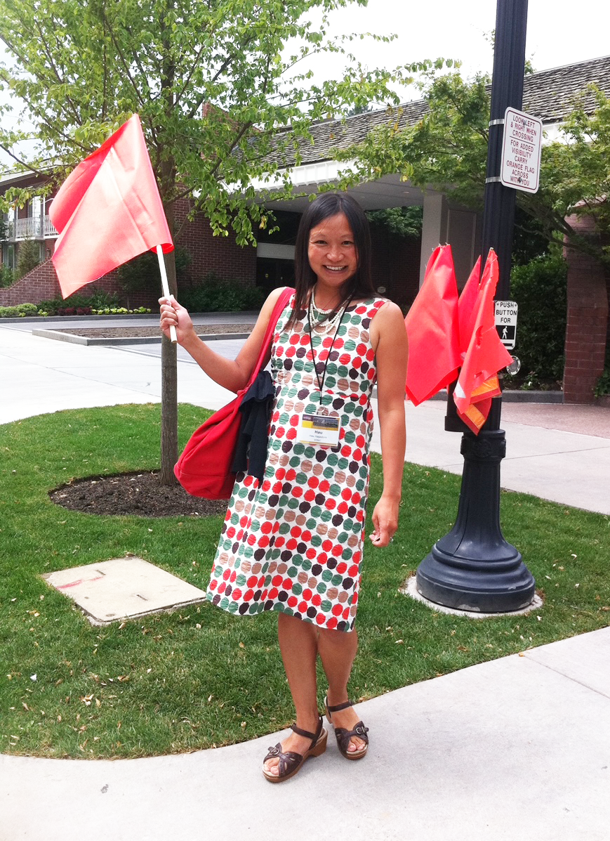 Hau Hagedorn demonstrates a pedestrian crossing flag in Salt Lake City, Utah.