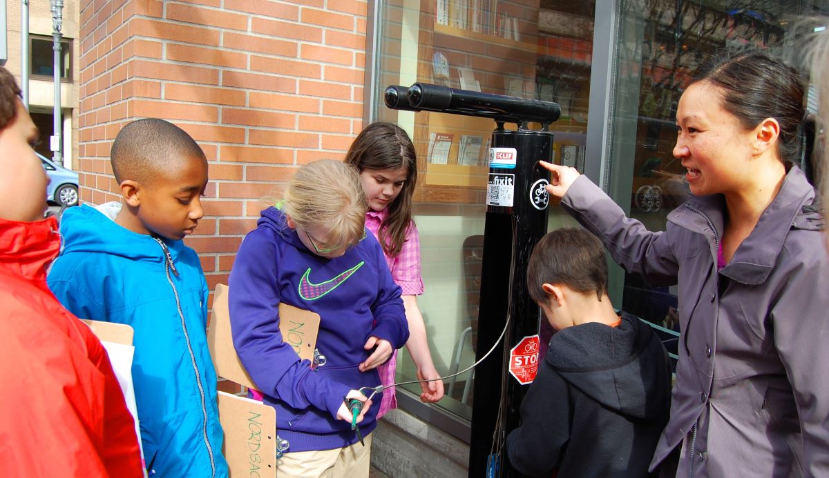 Hau leads a group of sixth graders on a 2013 transportation tour