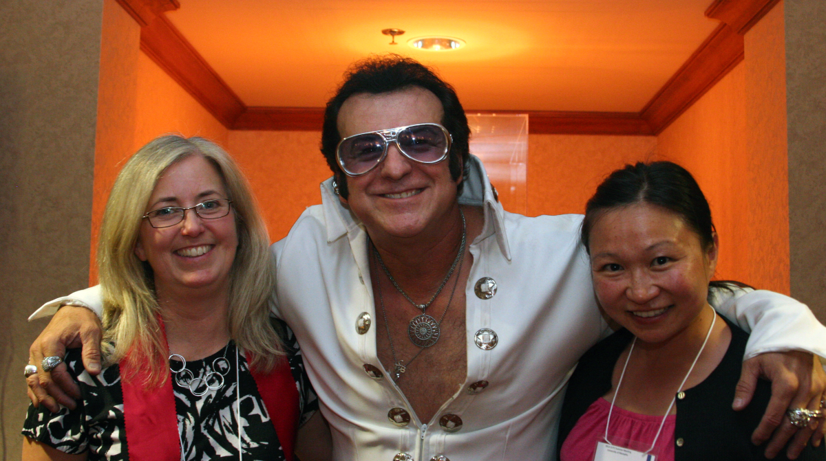 Jennifer Dill and Hau Hagedorn with an Elvis impersonator at a conference reception