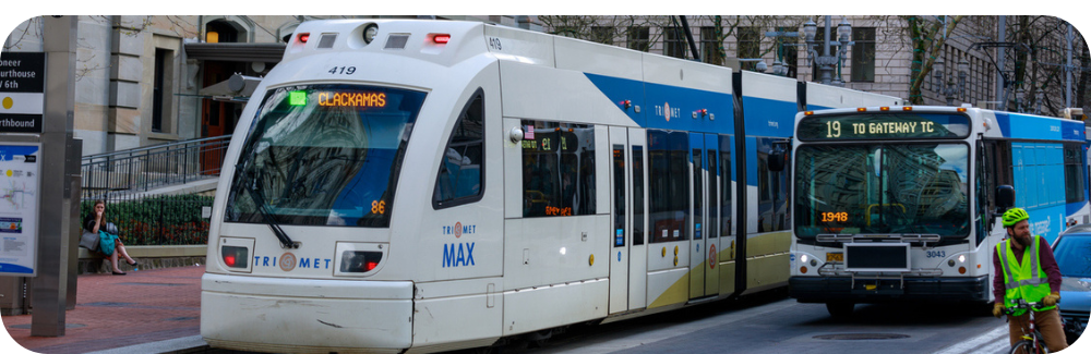 A TriMet bus next to a MAX Train