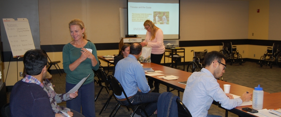 People talking and looking at materials in a workshop