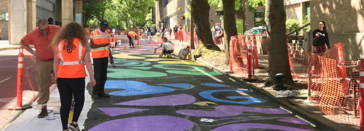 A student-designed street painting honoring Pride was painted by volunteers during the Montgomery Pop-Up Plaza.jpg (