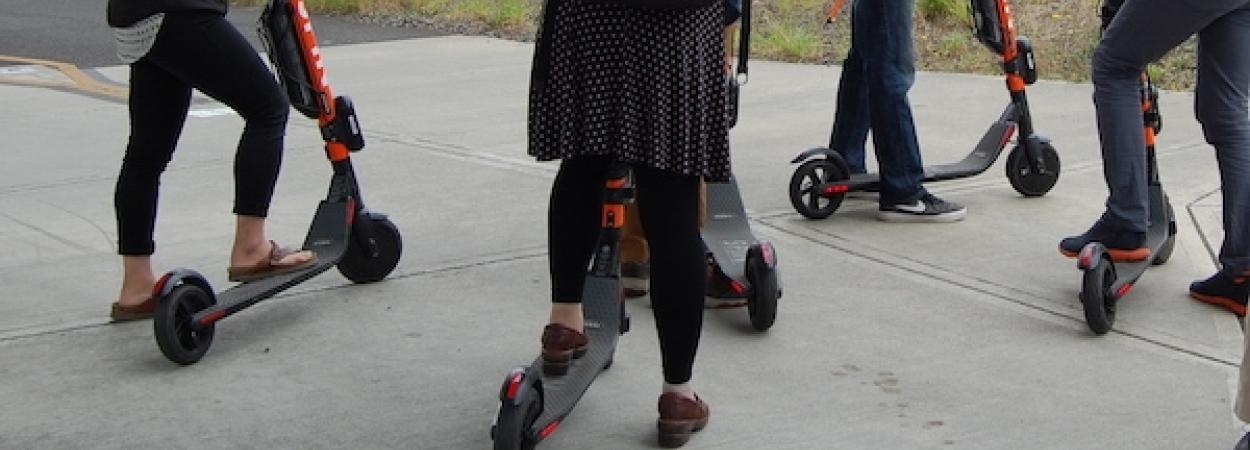 Comparing the Promise and Reality of E-Scooters: A Critical Assessment of Equity Improvements and Mode-Shift