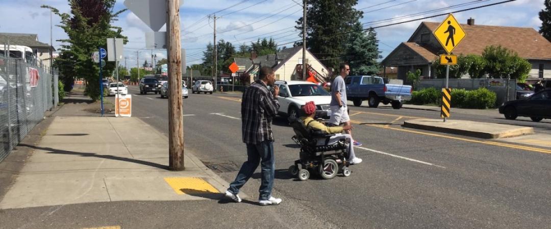 pedestrians cross the street