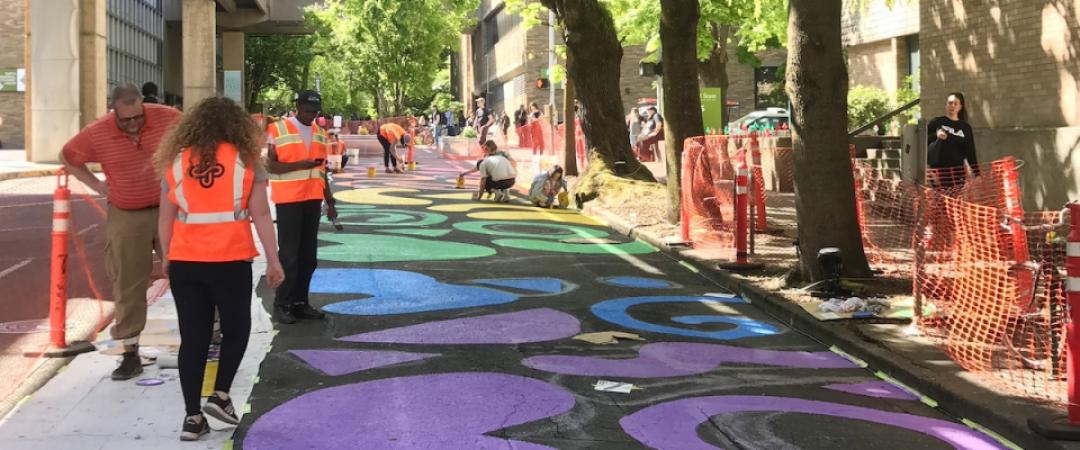 A student-designed street painting honoring Pride was painted by volunteers during the Montgomery Pop-Up Plaza.jpg (