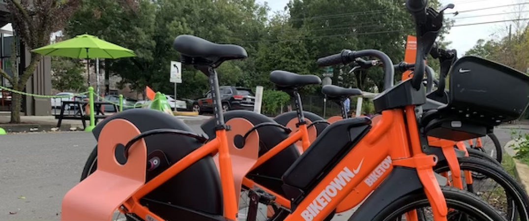 New electric bikes docked at a BIKETOWN bike share station in Portland, Oregon